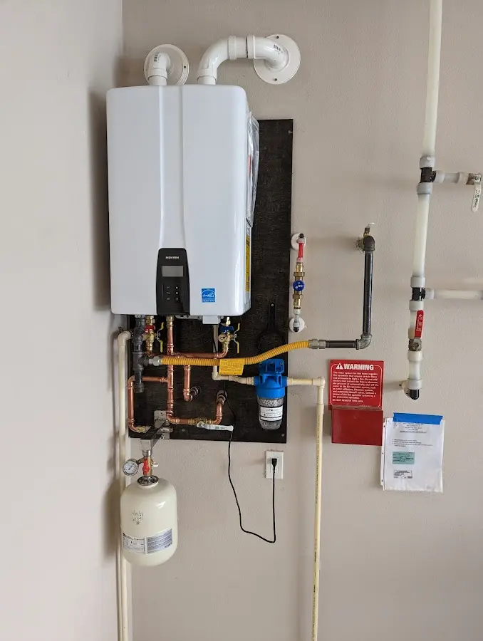 Professional plumber installing copper piping in a Acushnet home